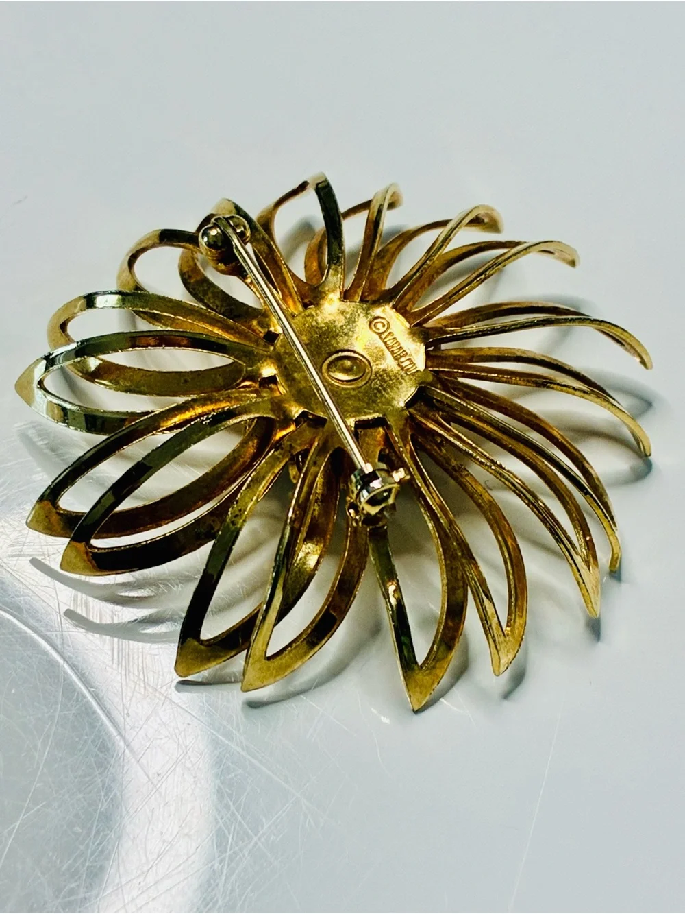 Sarah Coventry Gold-tone Sunburst Brooch with Deep Red Center